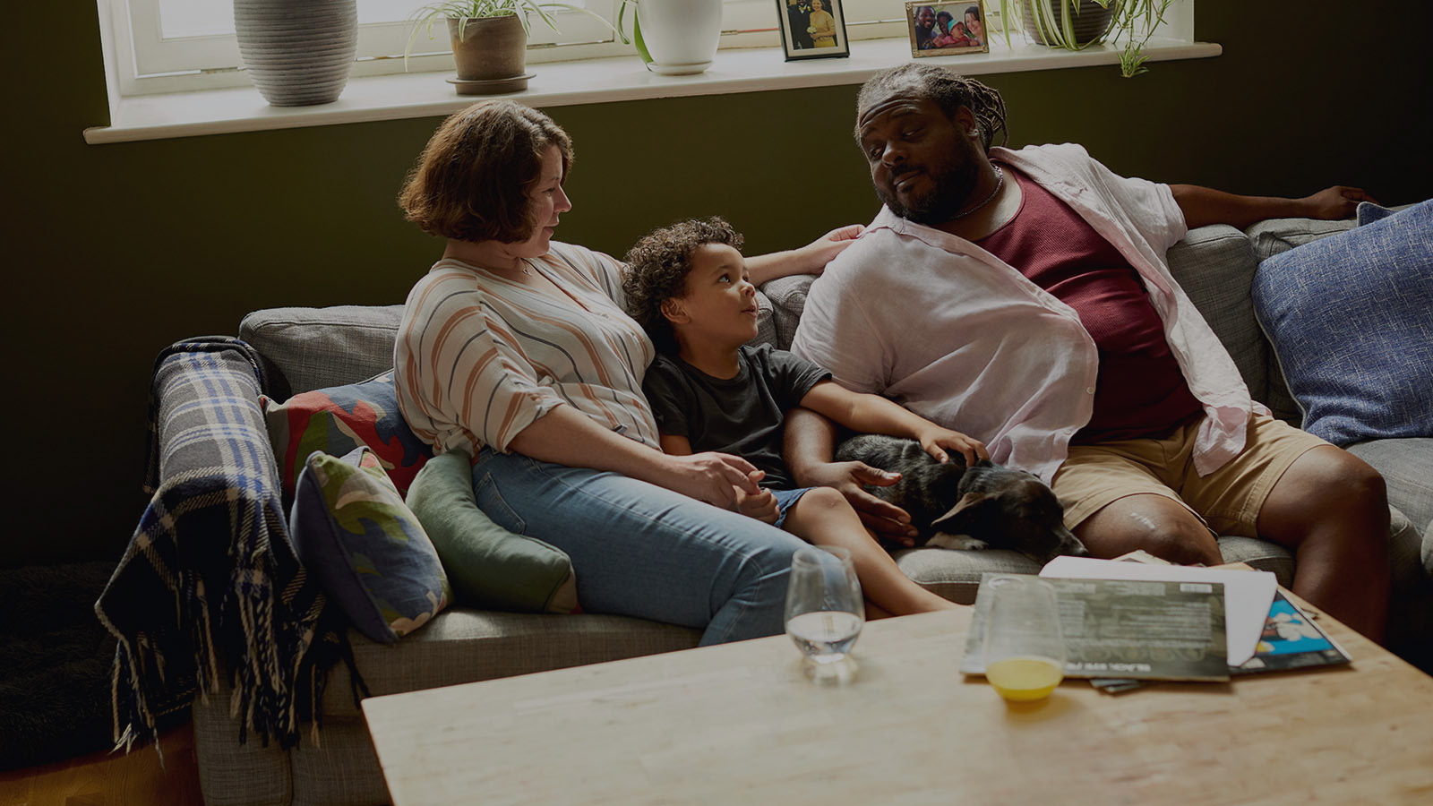 family relaxing on the sofa